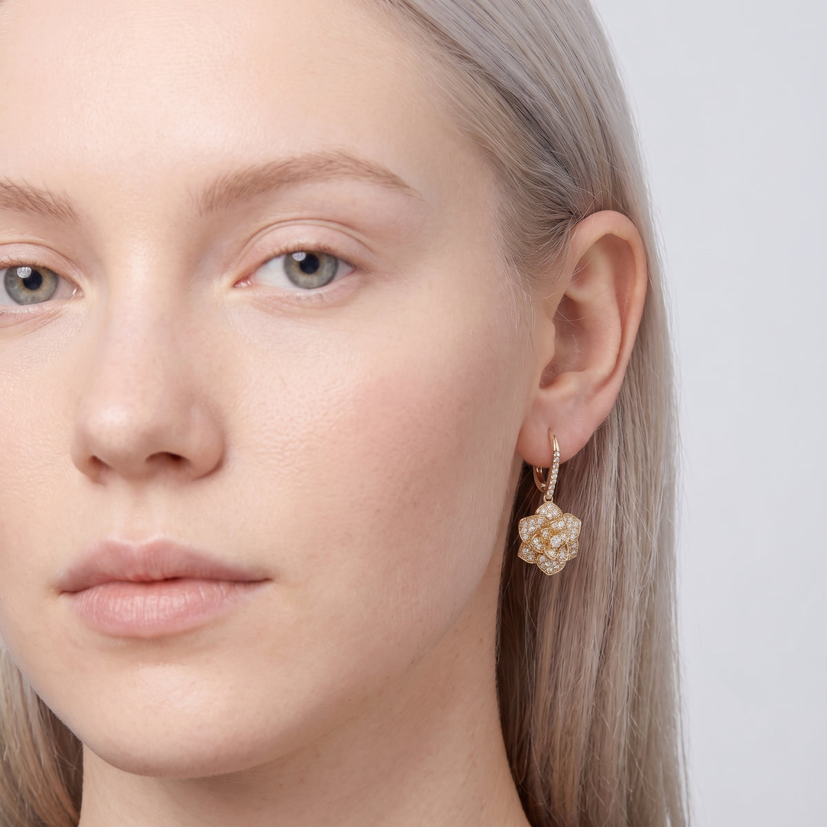 Model wearing the Lelice Crystal Rosette Gold Earrings, three-quarter face close-up