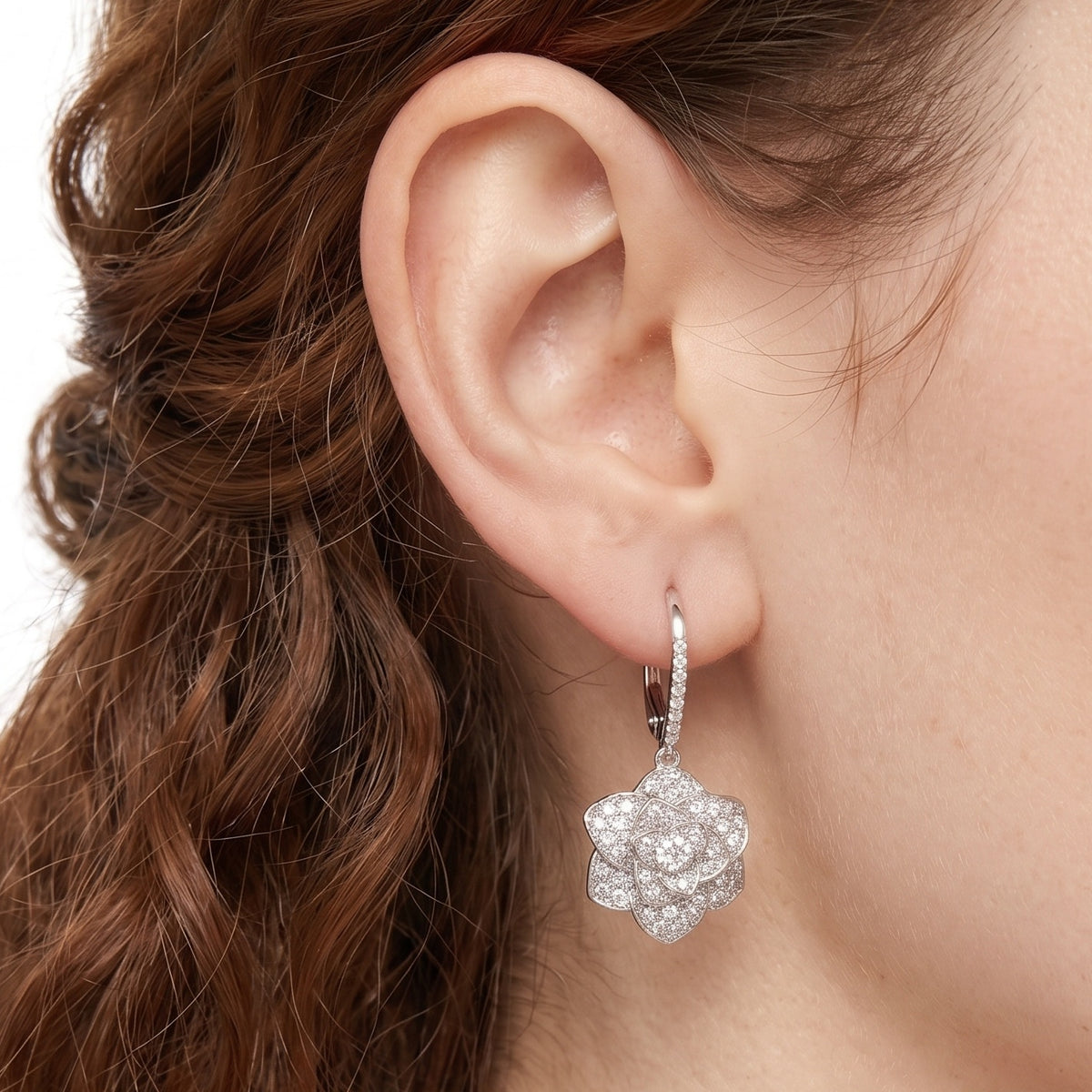 Close-up of the Lelice Crystal Rosette Silver Earrings on the ear