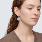 Model wearing the Lelice Crystal Rosette Silver Earrings, serene chin lift