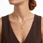 Close-up of the Lelice Crystal Teddy Bear Necklace in gold at the collarbone