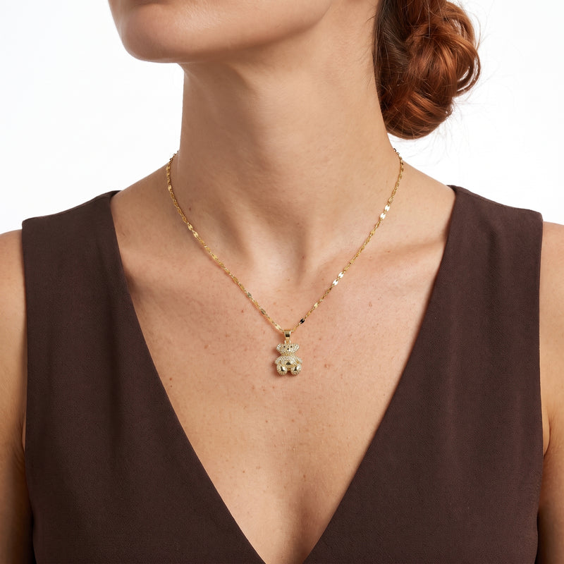 Close-up of the Lelice Crystal Teddy Bear Necklace in gold at the collarbone