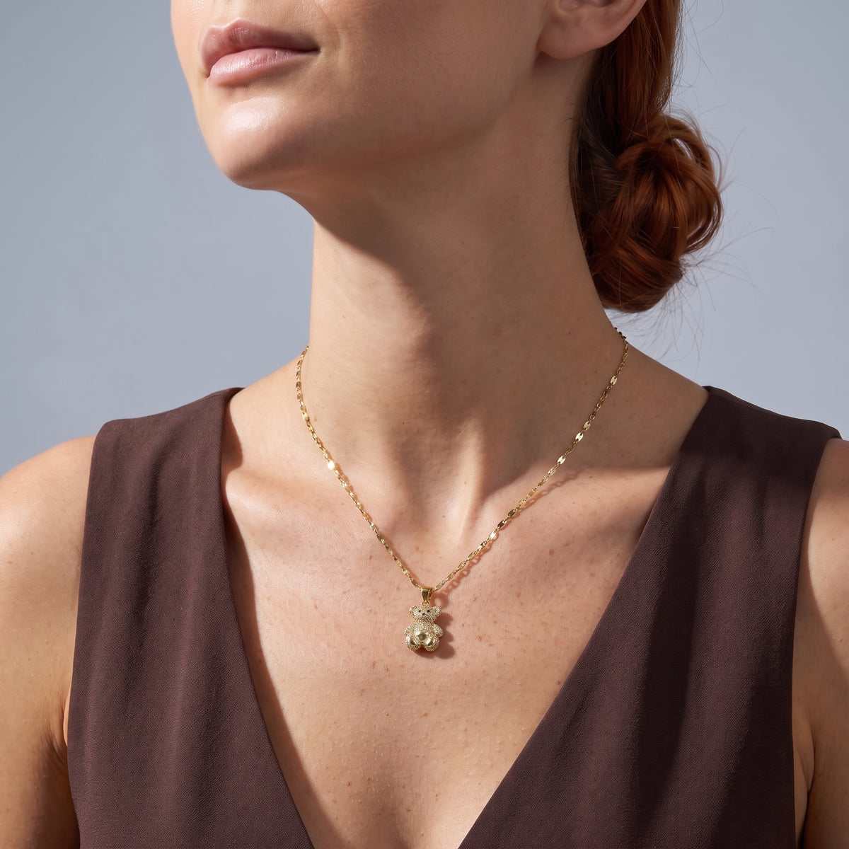 Low-angle portrait of a woman wearing the Crystal Teddy Bear Necklace