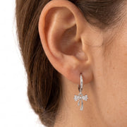 Close-up of the Lelice Dainty Bow Silver Hoops on the ear