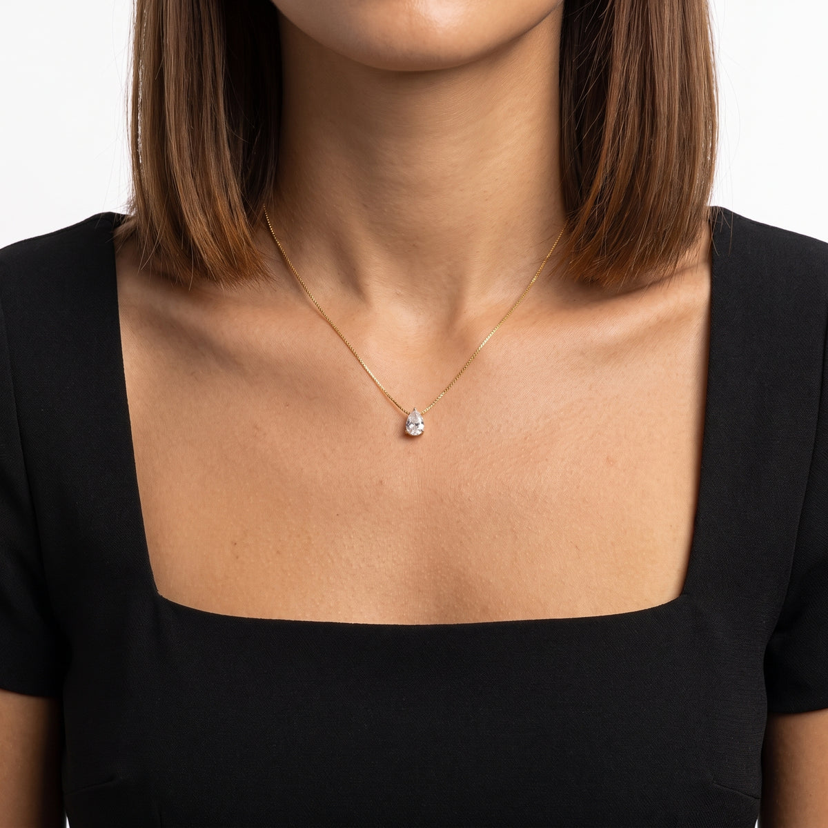Close-up of the Lelice Dainty Pear Drop Gold Necklace at the collarbone