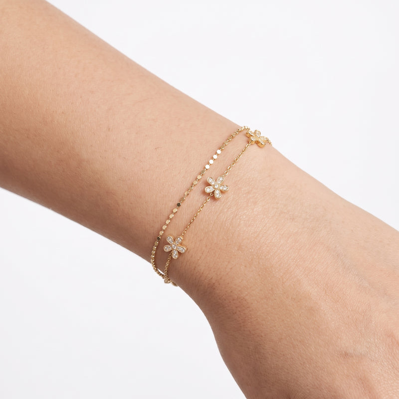 Close-up of the Lelice Daisy Flower Bracelet in gold on the wrist
