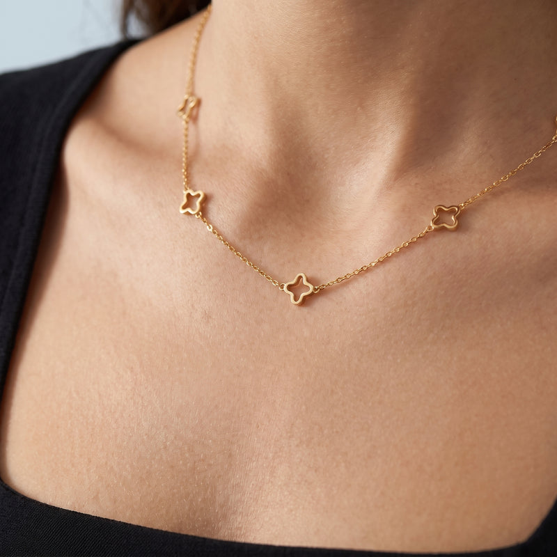 Close-up of the Daphne Clover Necklace resting on the skin