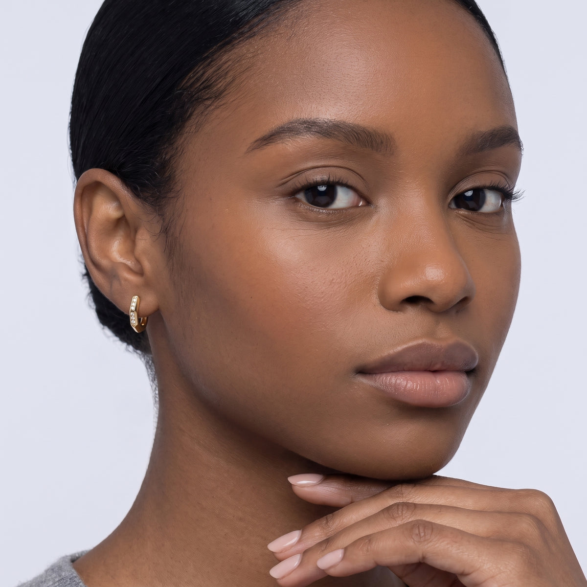 Model wearing the Lelice Demi Gold Hoops, hand at the chin