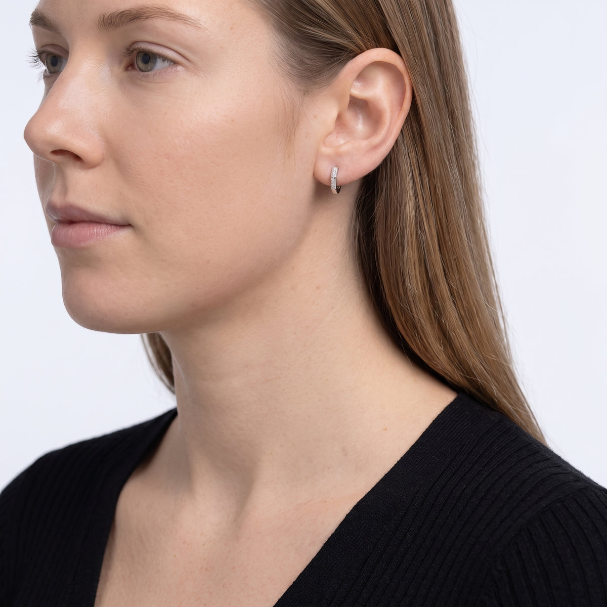 Model wearing the Lelice Demi Silver Hoops, ear and jaw, slightly wider