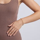 Model wearing the Lelice Diane Gold Bracelet, hand on the hip