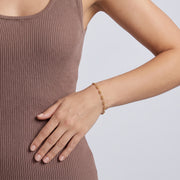Model wearing the Lelice Diane Gold Bracelet, hand on the hip