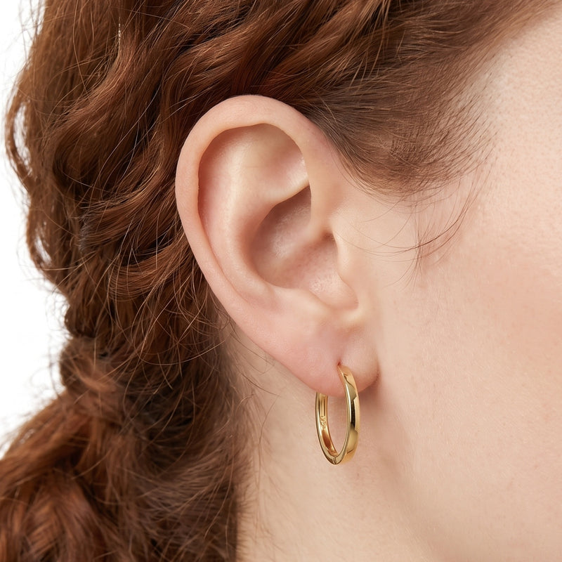 Close-up of the Lelice Diane Hoop Earrings in gold on the ear