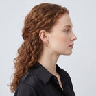 Model wearing the Lelice Diane Hoop Earrings in gold, sculpted side profile
