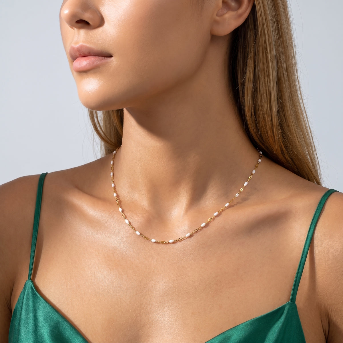 Woman in soft side light wearing the Eleni Beaded Necklace