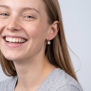 Model wearing the Lelice Elisa Crystal Earrings in gold, candid laugh