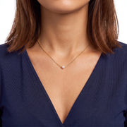 Close-up of the Lelice Elise Pearl Necklace in gold at the collarbone
