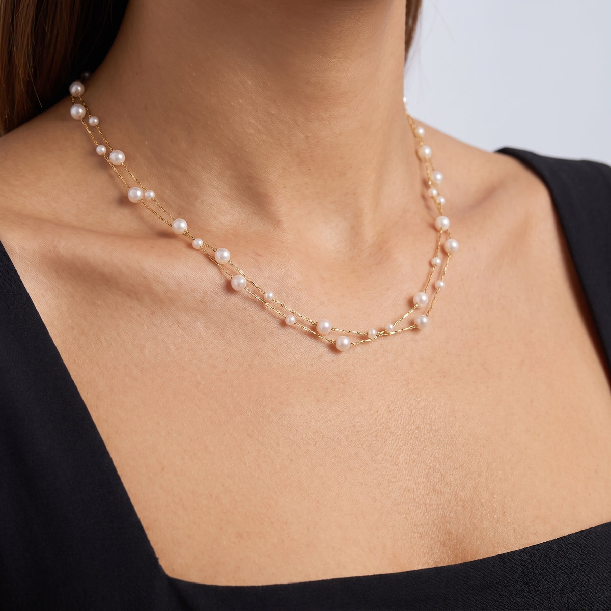 Close-up of the Ella Pearl Necklace resting on the skin