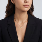 Shoulders and neckline of a woman wearing the Esme Clover Necklace
