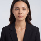 Portrait of a woman wearing the Esme Clover Necklace