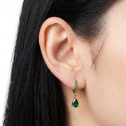 Close-up of the Lelice Esme Emerald Hoops in gold on the ear