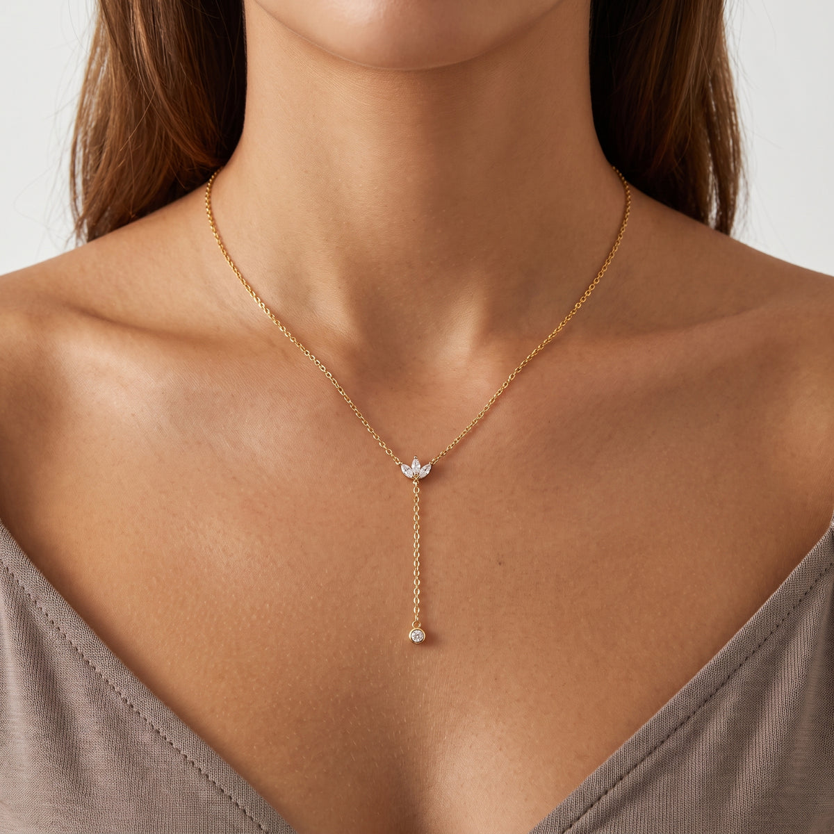 Close-up of the Lelice Esme Lariat Necklace in gold at the collarbone