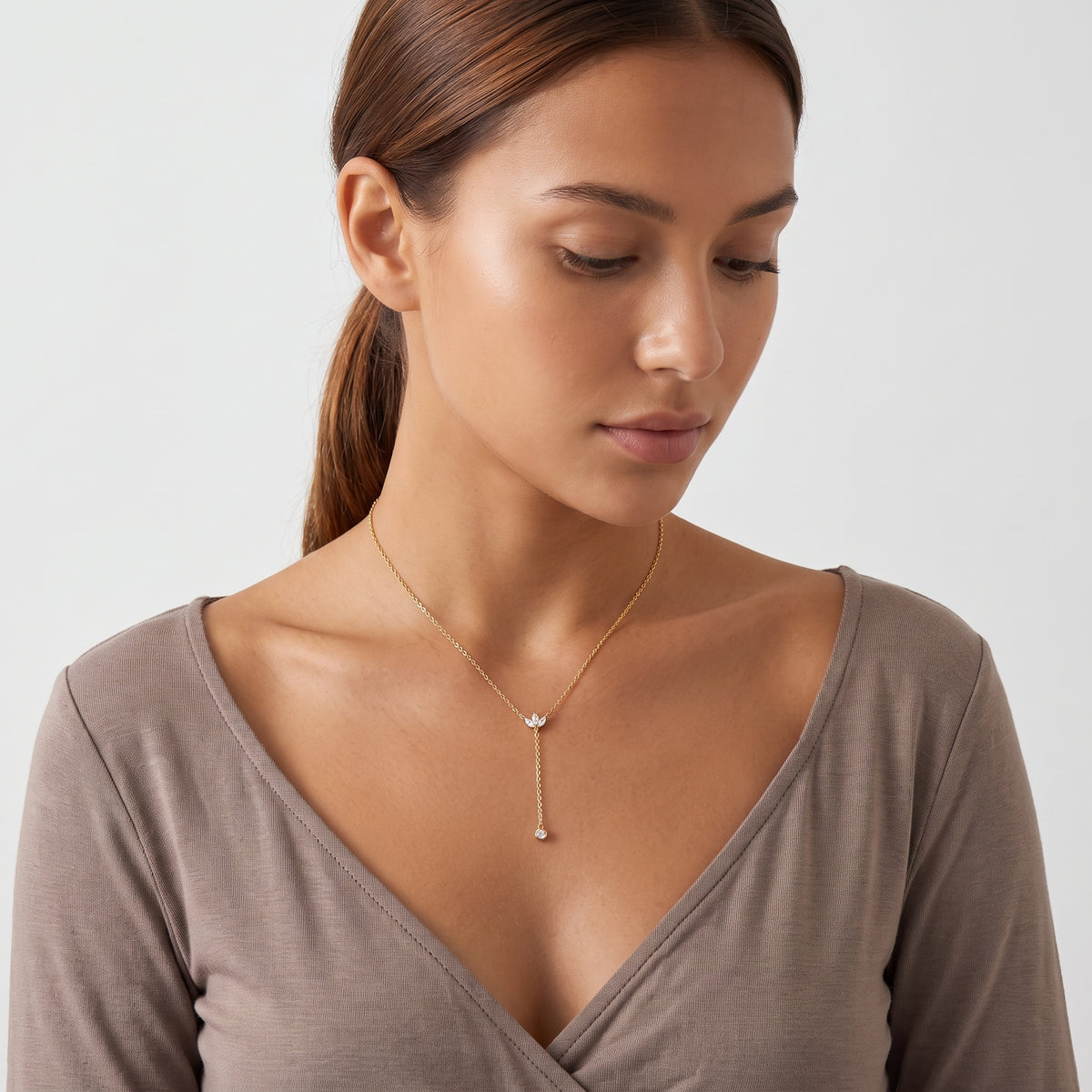 Woman looking down at the Esme Lariat Necklace