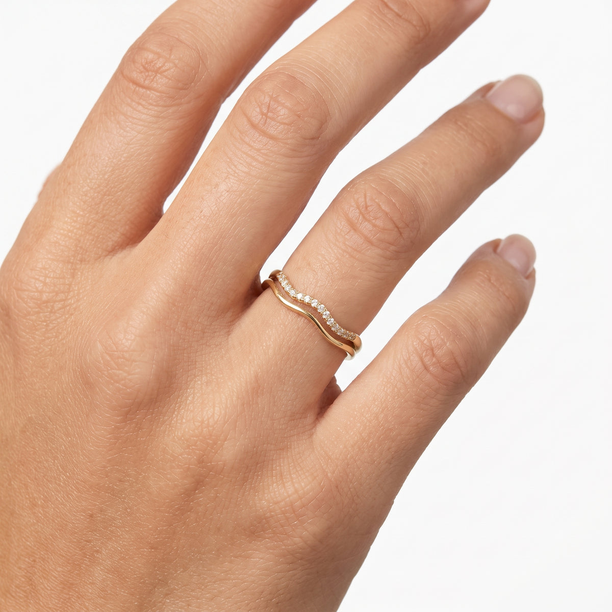 Hand wearing Lelice gold double wave crystal ring Estelle