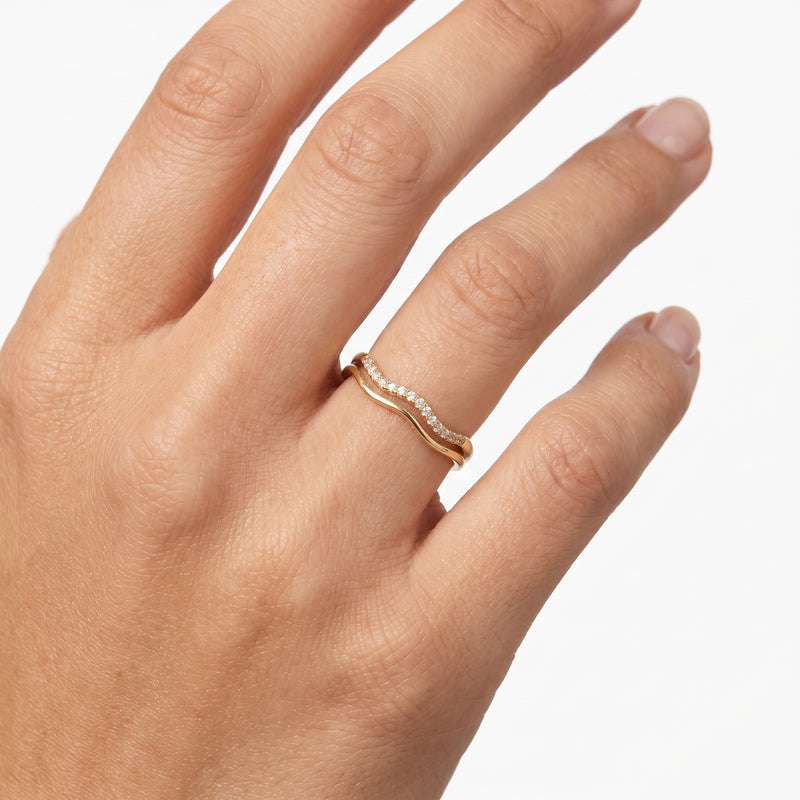 Hand wearing Lelice gold double wave crystal ring Estelle