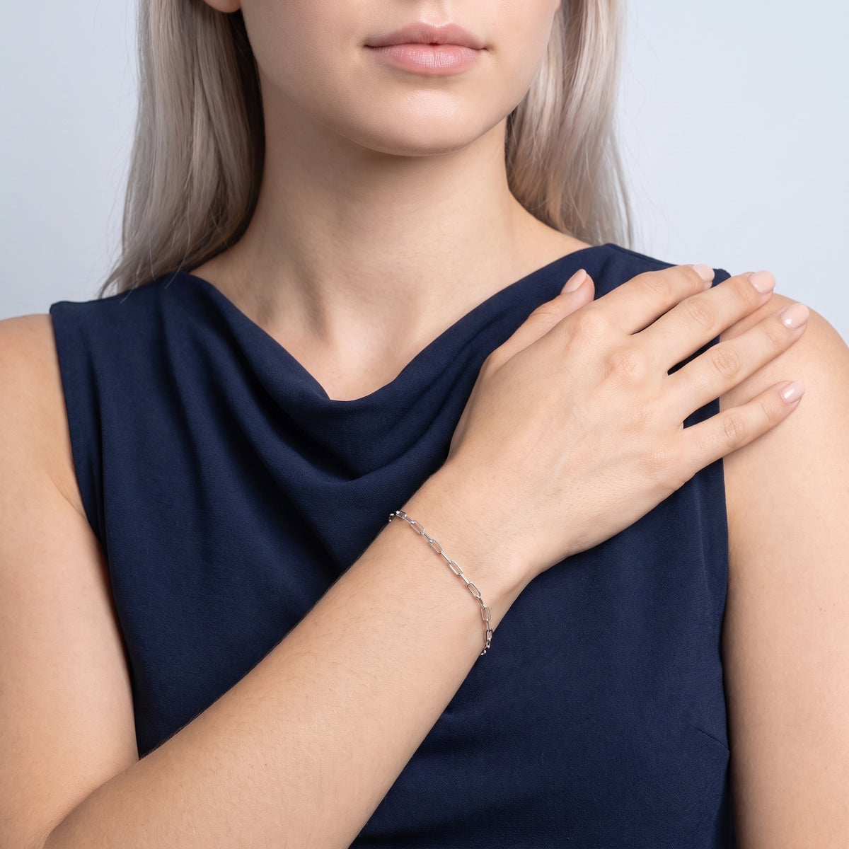 Model wearing the Lelice Esther Silver Bracelet, hand on the opposite shoulder