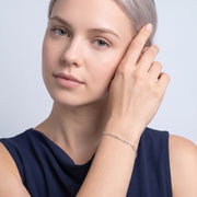 Model wearing the Lelice Esther Silver Bracelet, hand at the face