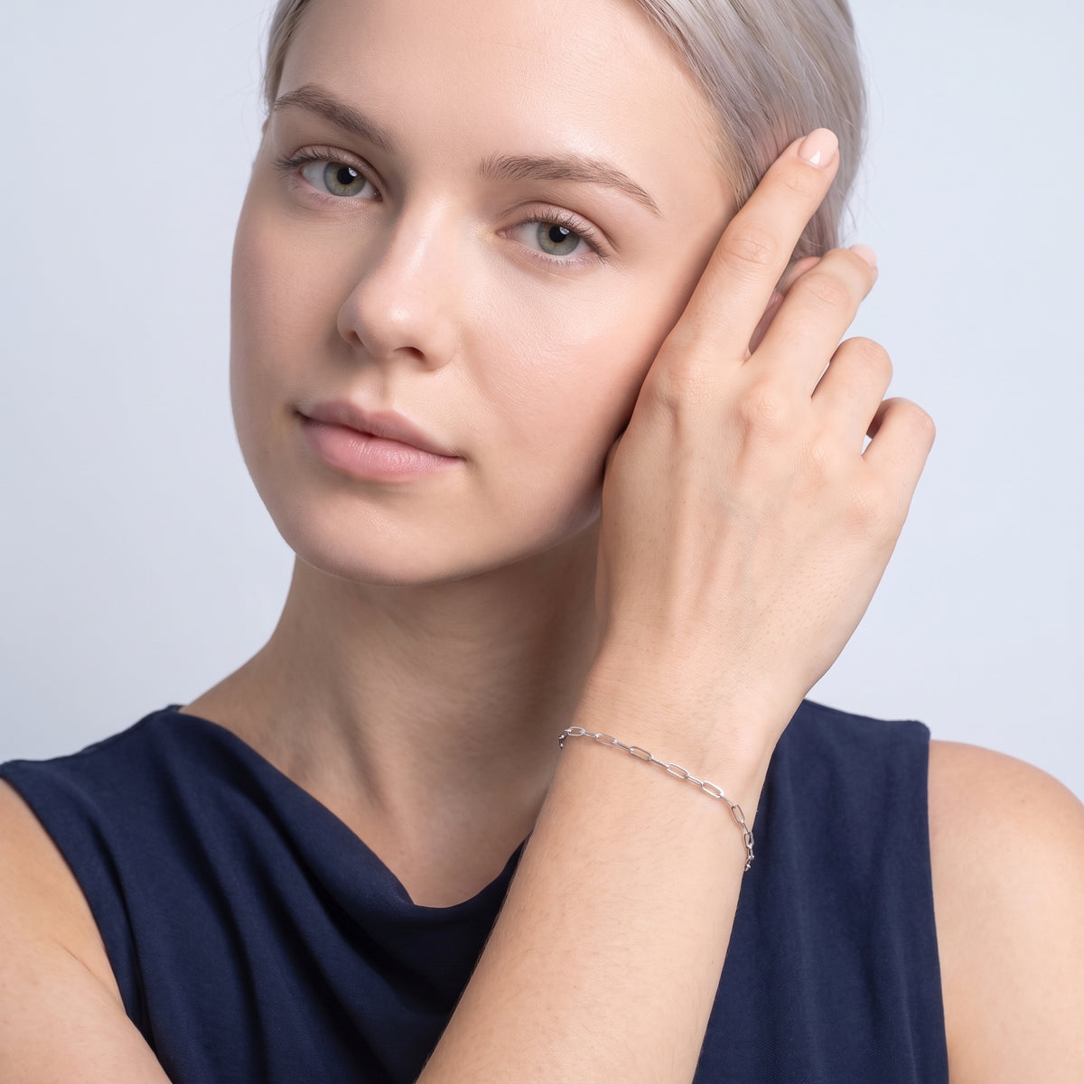 Model wearing the Lelice Esther Silver Bracelet, hand at the face