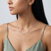 Three-quarter profile of a woman wearing the Esther Sparkle Necklace