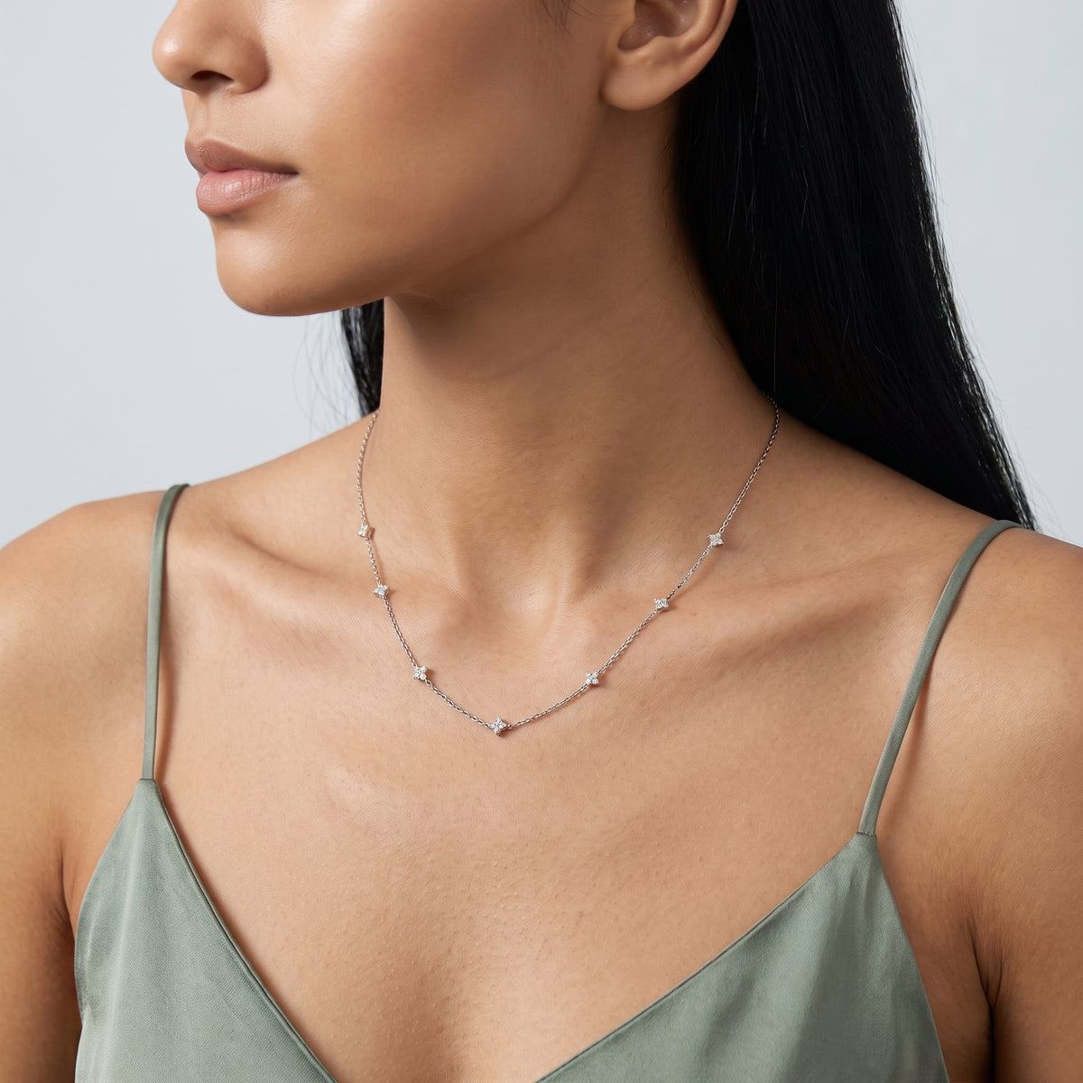 Three-quarter profile of a woman wearing the Esther Sparkle Necklace
