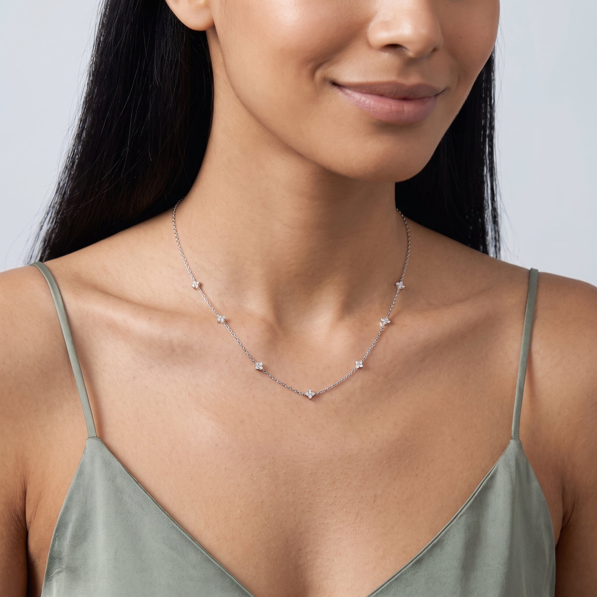 Woman with head tilted down wearing the Esther Sparkle Necklace