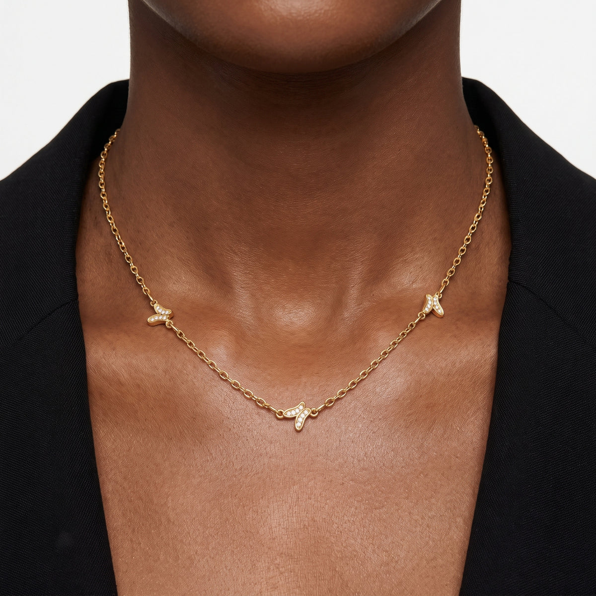 Close-up of the Lelice Faye Butterfly Necklace in gold at the collarbone