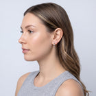 Model wearing the Lelice Felicity Lucky Hoop in gold, side profile portrait