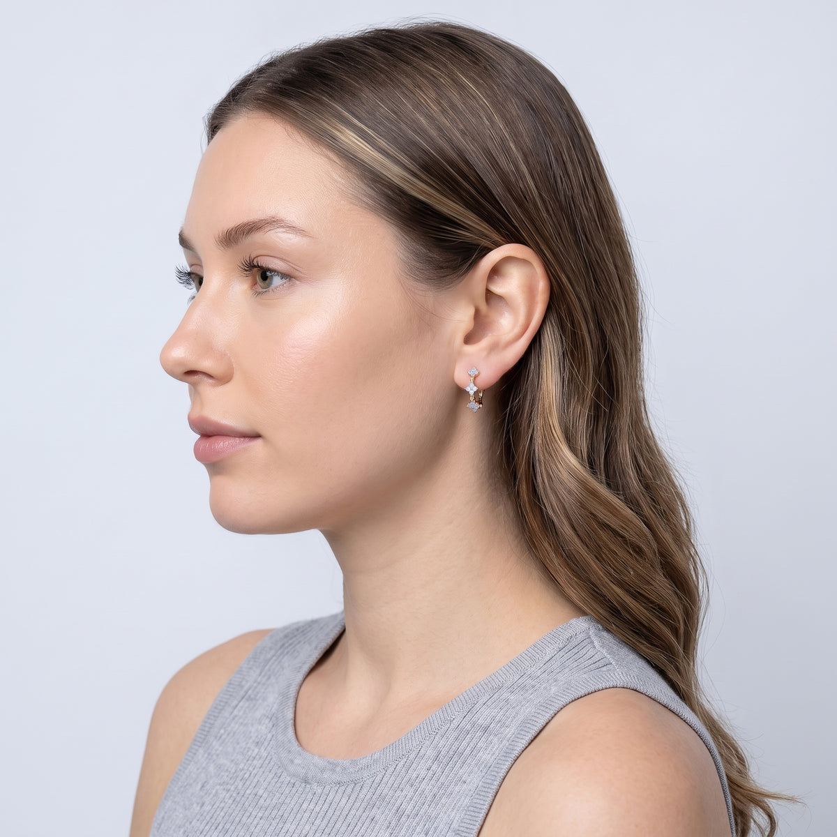 Model wearing the Lelice Felicity Lucky Hoop in gold, side profile portrait