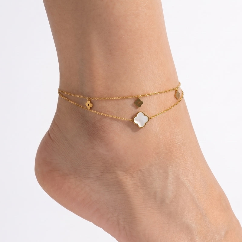 Close-up of the Lelice Fiora Clover Charm Anklet in gold on a woman's ankle