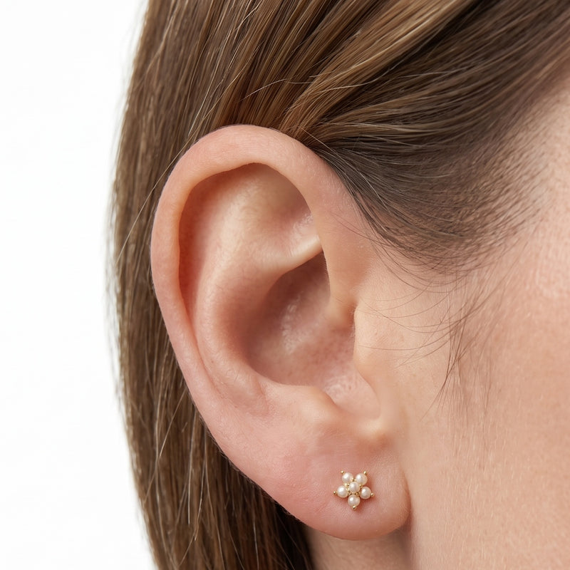 Close-up of the Lelice Fleur Pearl Earrings in gold on the ear
