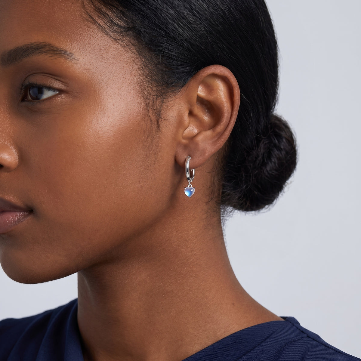 Model wearing the Lelice Florence Silver Hoops in silver, ear and jaw, slightly wider