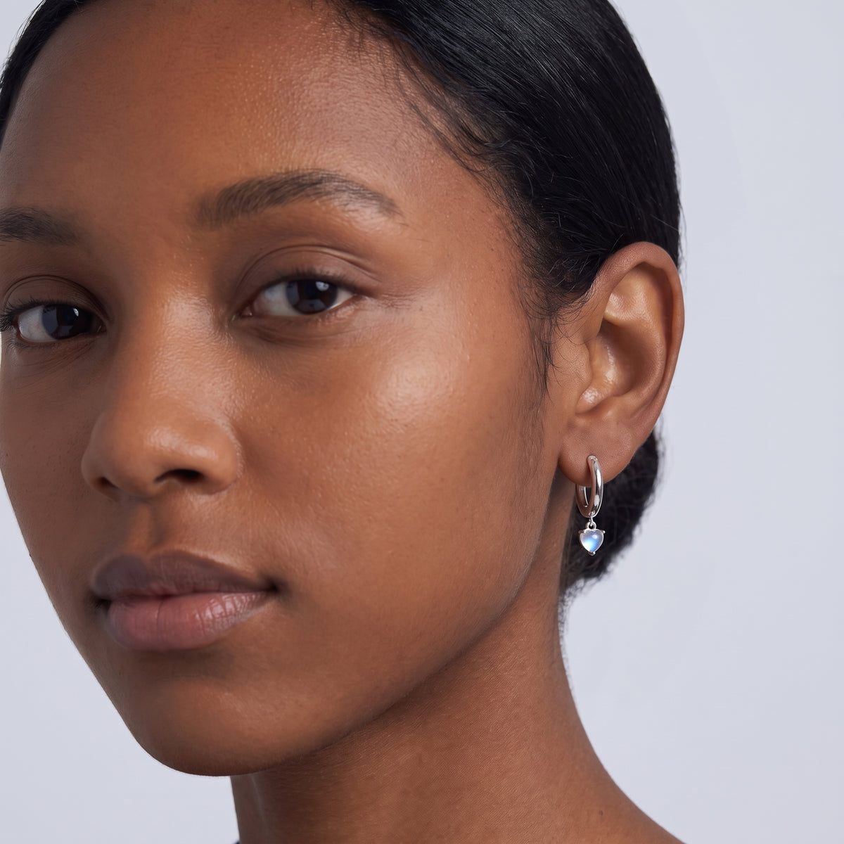 Model wearing the Lelice Florence Silver Hoops in silver, three-quarter face close-up