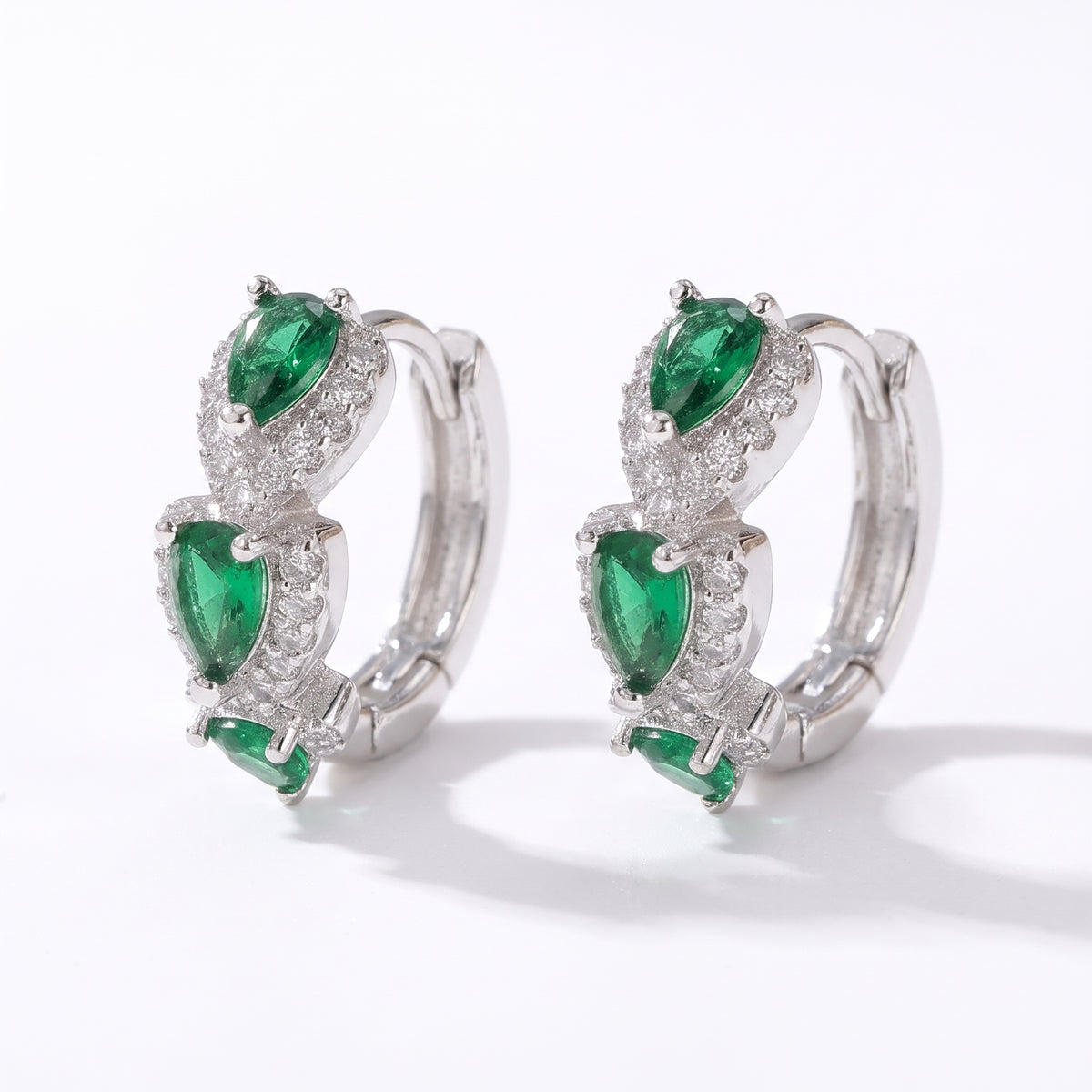 Lelice Forest Emerald Hoops in silver on a white background