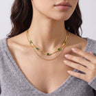 Hand at the collar of a woman wearing the Gatsby Green Double Chain