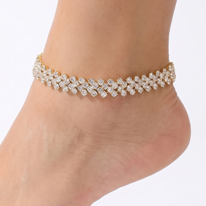Close-up of the Lelice Gold Riviera Anklet on a woman's ankle