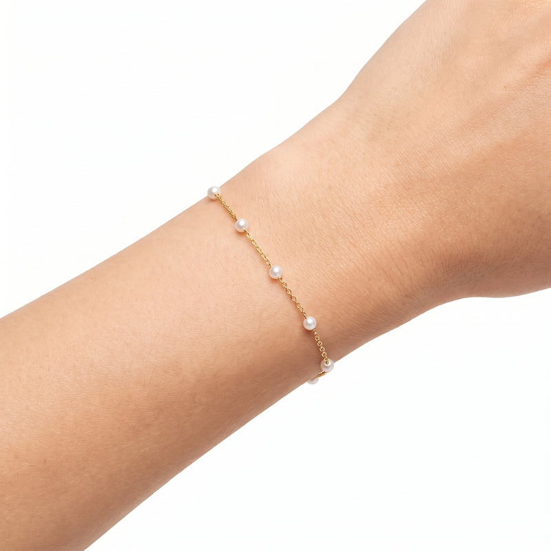 Close-up of the Lelice Grace Pearl Bracelet in gold on the wrist