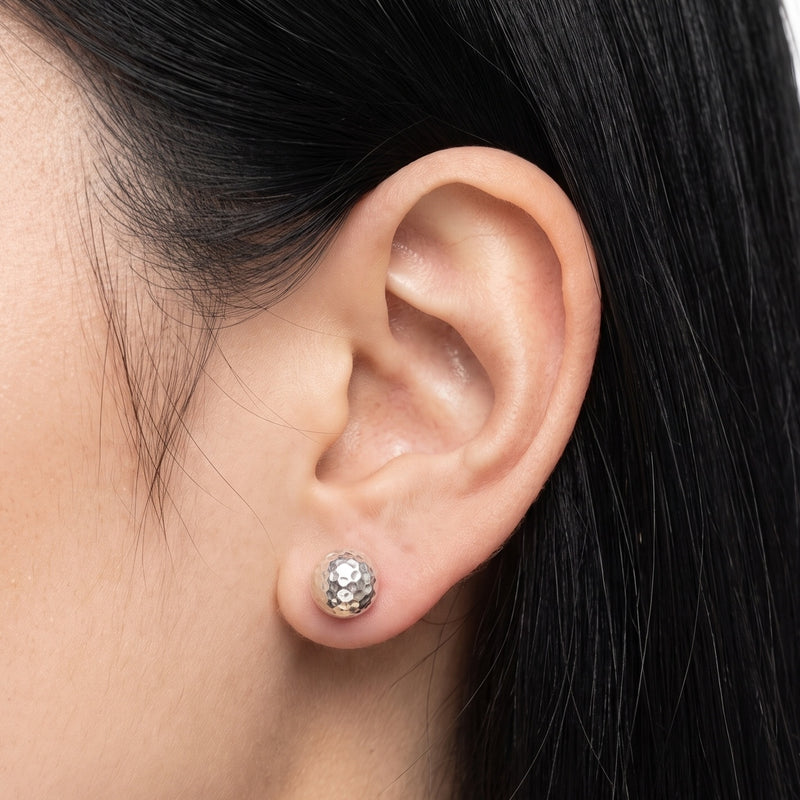 Close-up of the Lelice Hammered Silver Studs on the ear
