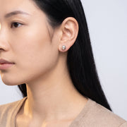 Model wearing the Lelice Hammered Silver Studs, turned toward the light