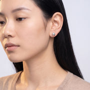 Model wearing the Lelice Hammered Silver Studs, downcast beauty portrait