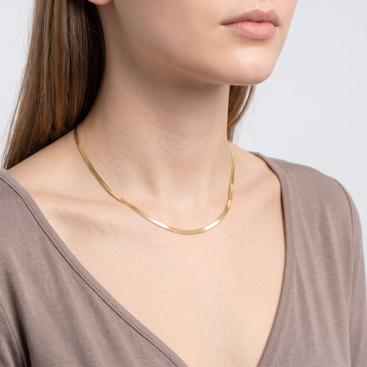 Woman turned three-quarters wearing the Harper Herringbone Necklace