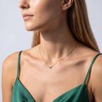 Woman in soft side light wearing the Hélène Three Stone Necklace