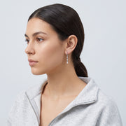 Model wearing the Lelice Héloïse Silver Drops in silver, slicked-back profile
